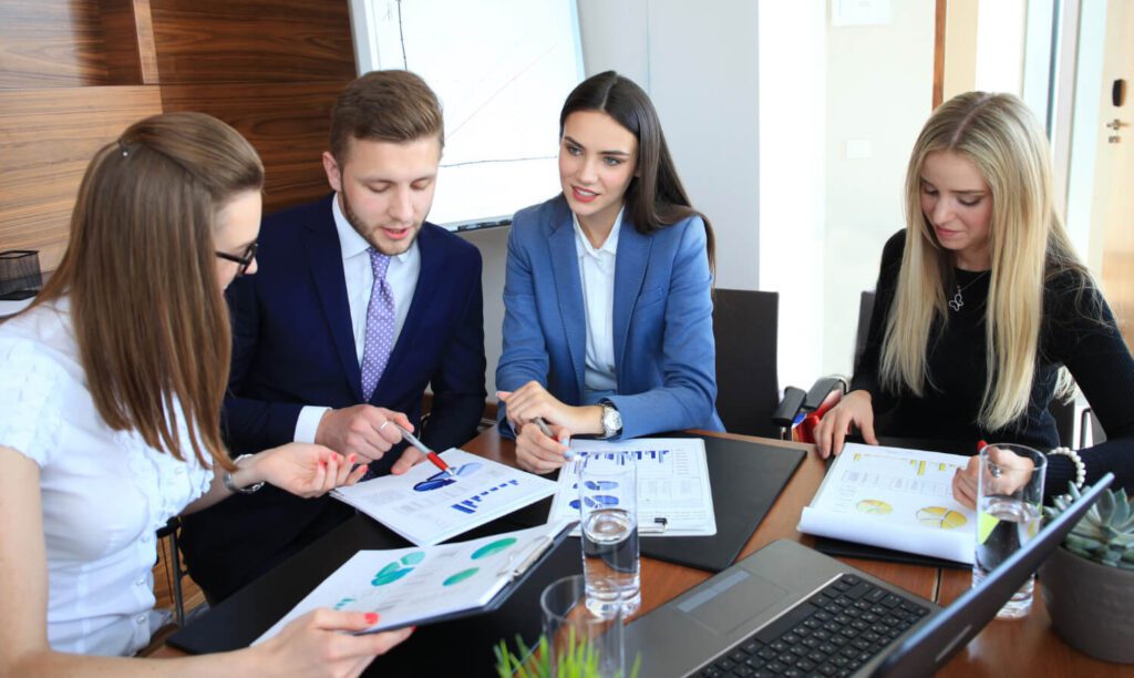 Business team discussing documents in a meeting room.